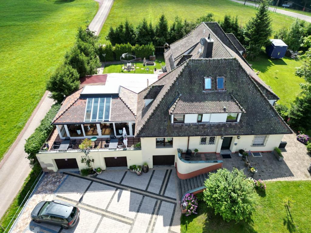 an aerial view of a large house with a car at Apartment Haus Pflingsteck nahe Europa Park Rulantica in Freiamt