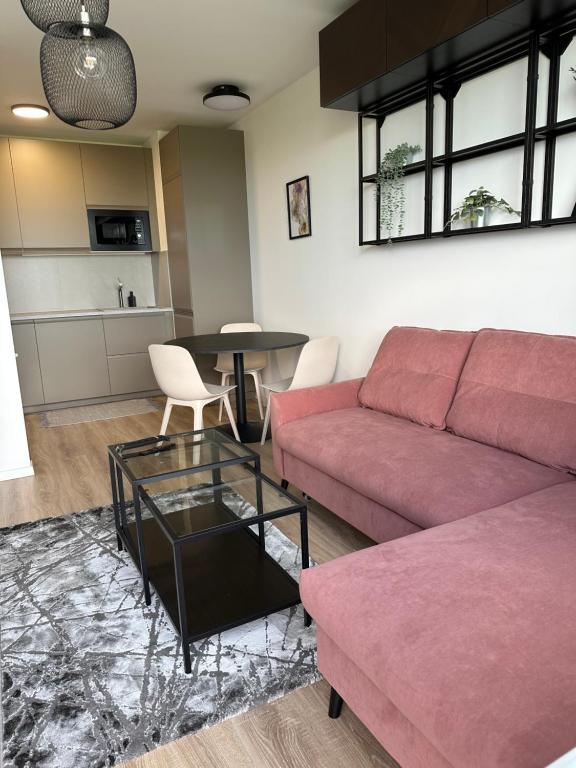 a living room with a couch and a table at 2 room Apartment, new building, near Airport, Ovocné sady, in Prievoz