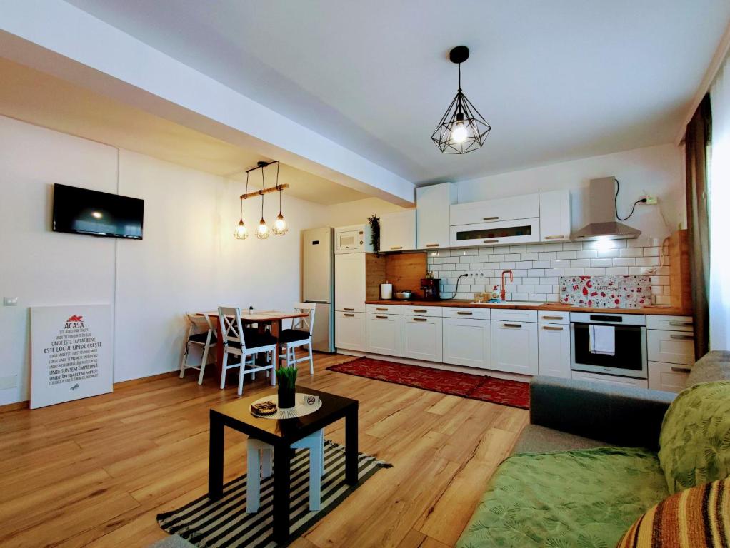 a living room with a kitchen and a table at River side apartment with terrace in Floreşti