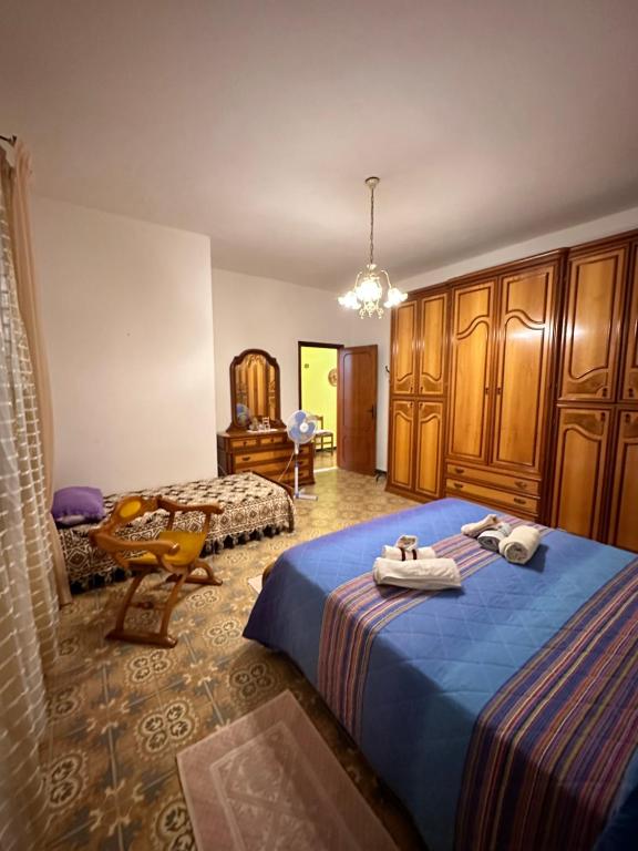 a bedroom with two beds with towels on them at Sa Domu de Cri in Giba