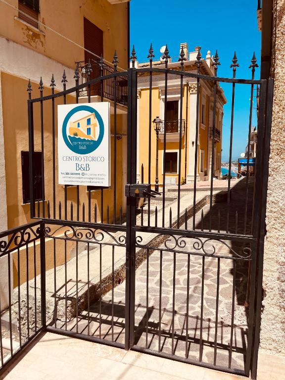 a gate with a sign in front of a building at B&B Centro Storico in Diamante