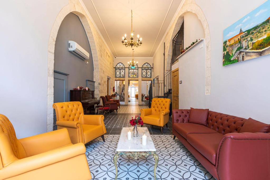 a living room with couches and chairs and a table at Michel House in Nazareth