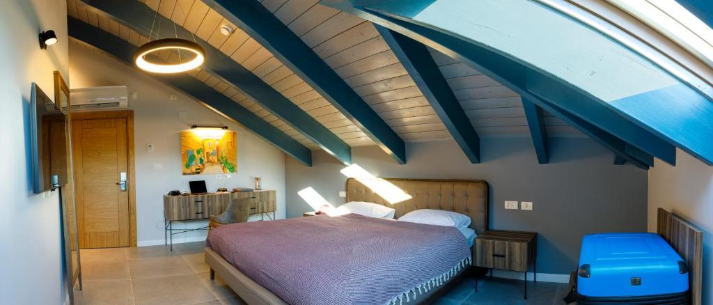 a bedroom with a bed in a room with an attic at Michel House in Nazareth