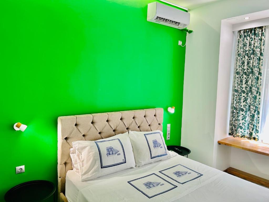 a green bedroom with a bed with a green wall at CASA VERDE di Giorgio 10 mins walk from Piraeus port in Piraeus