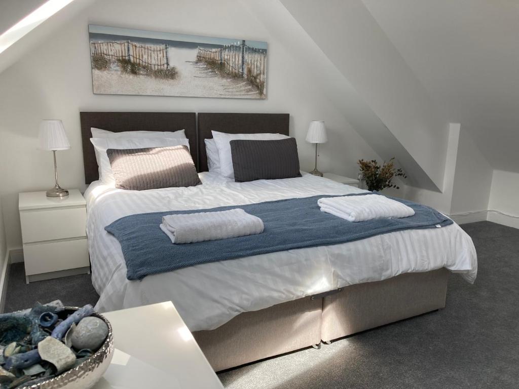 a bedroom with a large bed with two pillows at Town House in Cowes in Cowes