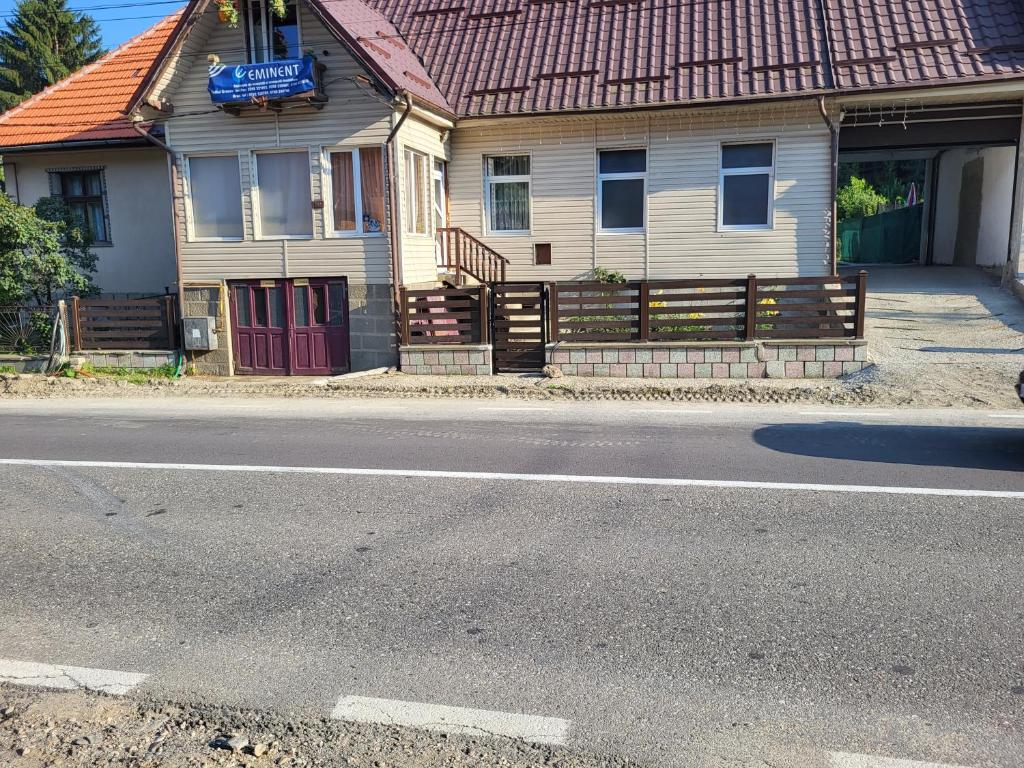 a house on the side of the road with a street at Casa ERNST in Moieciu de Jos