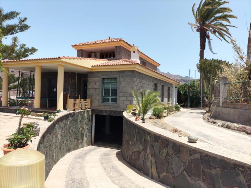 una casa con una pared de piedra en Casita Lily en Las Palmas de Gran Canaria