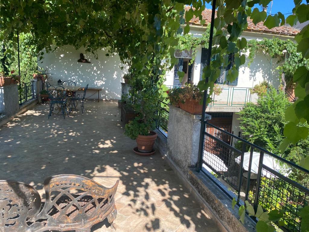 a patio with a bench and a table and chairs at La Stalla in Tuscania