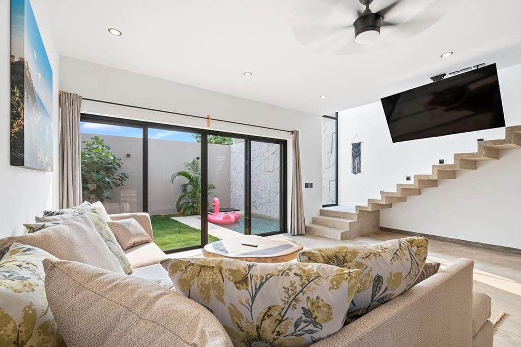 a living room with a couch and a tv at Quiet La Punta Surf Villa in Puerto Escondido
