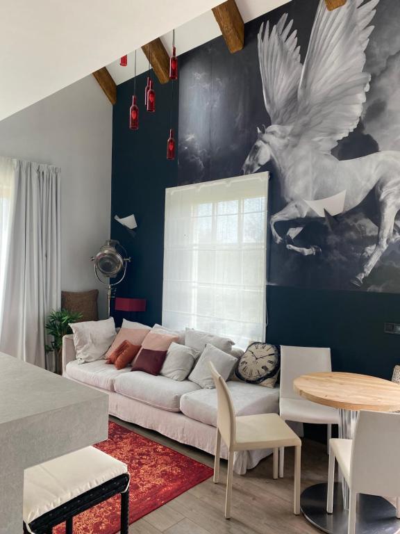 a living room with a couch and a painting of a horse at Villa Lavender in Felsőörs