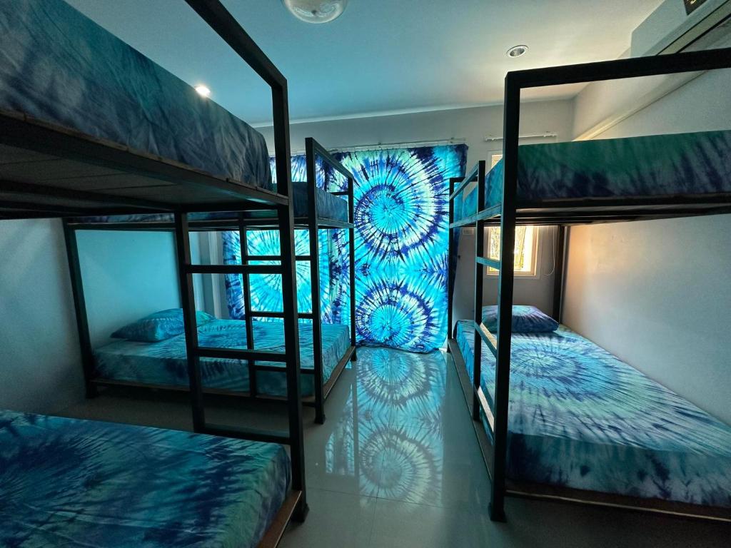 a room with three bunk beds in a hostel at Freedom​ Hostel​ in Khao Lak