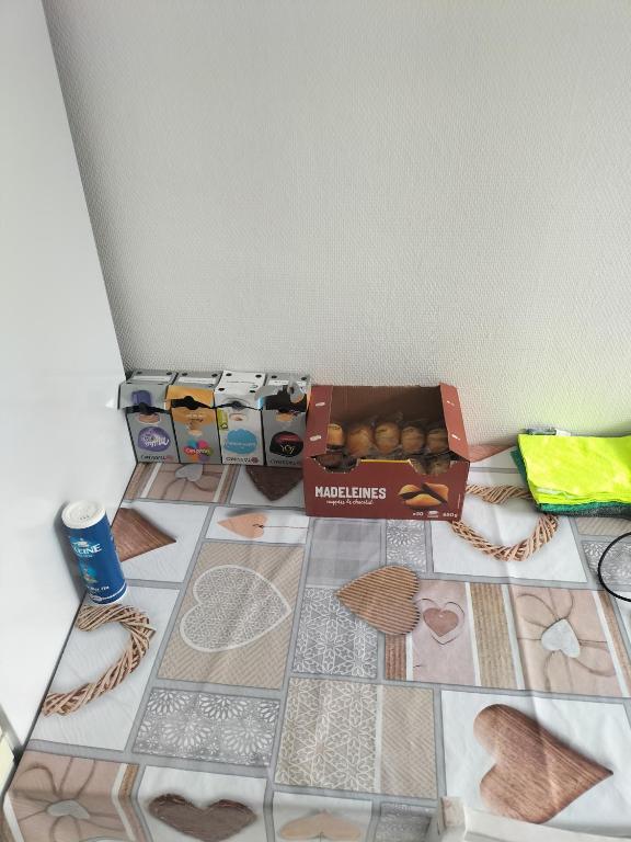 a box of donuts sitting on a tiled floor at Joli appartement proche métro in Lyon