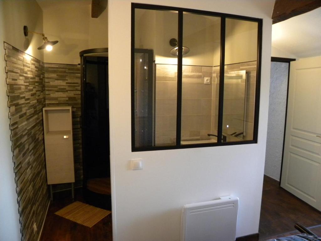 a bathroom with a glass shower in a room at les figuiers et les rosiers proche puy du fou in Saint-Germain-de-Prinçay