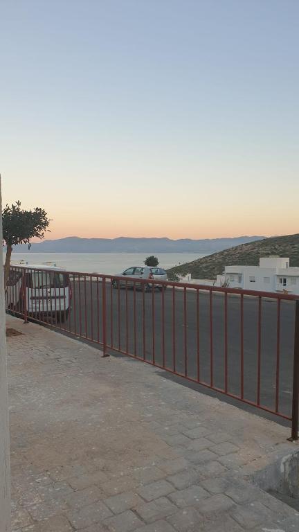 a red fence next to a body of water at Dar l Bihar in Al Hoceïma