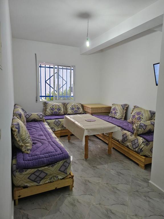 Sala de estar con 2 sofás y mesa en Dar l Bihar en Ajdir