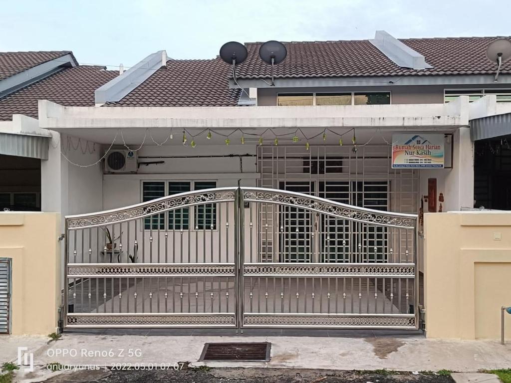 a gate in front of a house at Nurkasih Homestay Jerantut in Jerantut