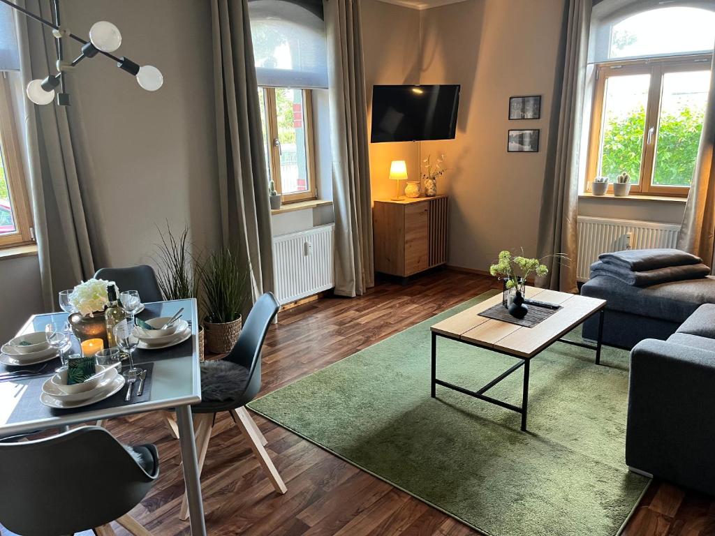 a living room with a couch and a table at Ferienwohnung Am Bürgerteich in Bischofswerda