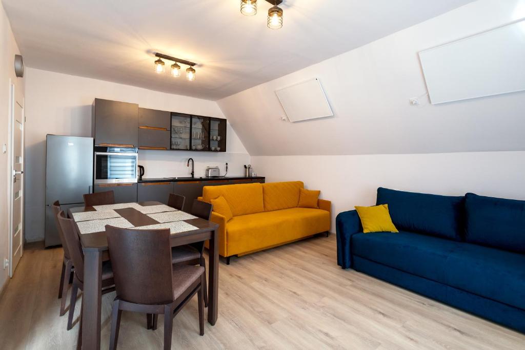 a living room with a dining table and a couch at Mega widok 4 in Szklarska Poręba