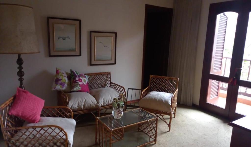a living room with chairs and a couch and a table at Mi habitación en Salta cerca de todo ! in Salta