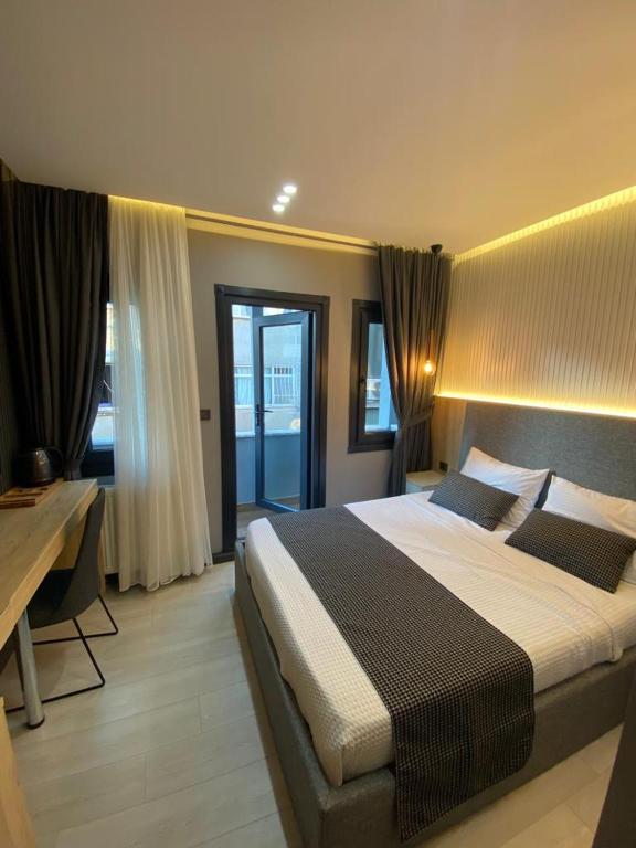 a large bedroom with a large bed and a desk at Santra Bosphorus Hotel in Istanbul