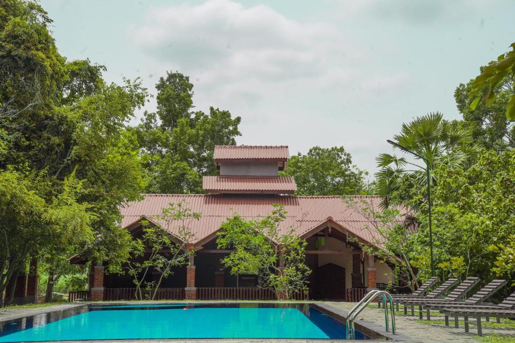 a resort with a swimming pool and a building at Foresta Resort Sigiriya in Sigiriya