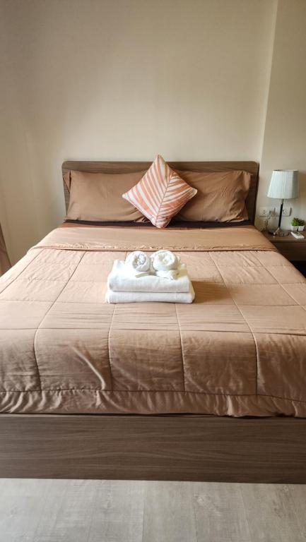 ein Bett mit zwei Handtüchern darüber in der Unterkunft Apple's La casita condo in Hua Hin in Hua Hin