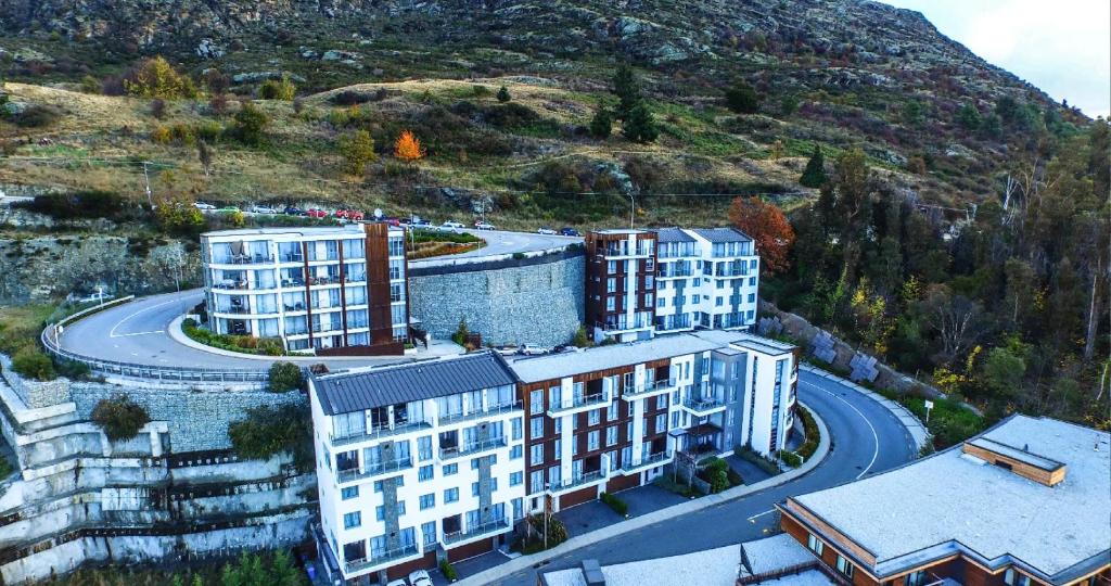 an aerial view of buildings in front of a mountain at Queenstown Village Apartments in Queenstown