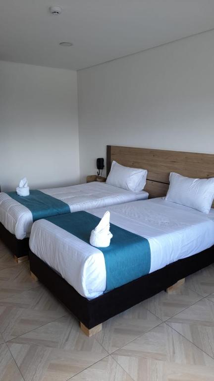Postel nebo postele na pokoji v ubytování Hotel Royal Cid Bogota