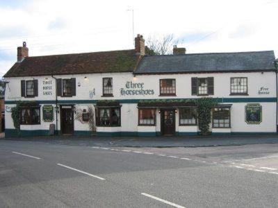 a large white building on the side of a street at The Three Horseshoes in Drayton Parslow