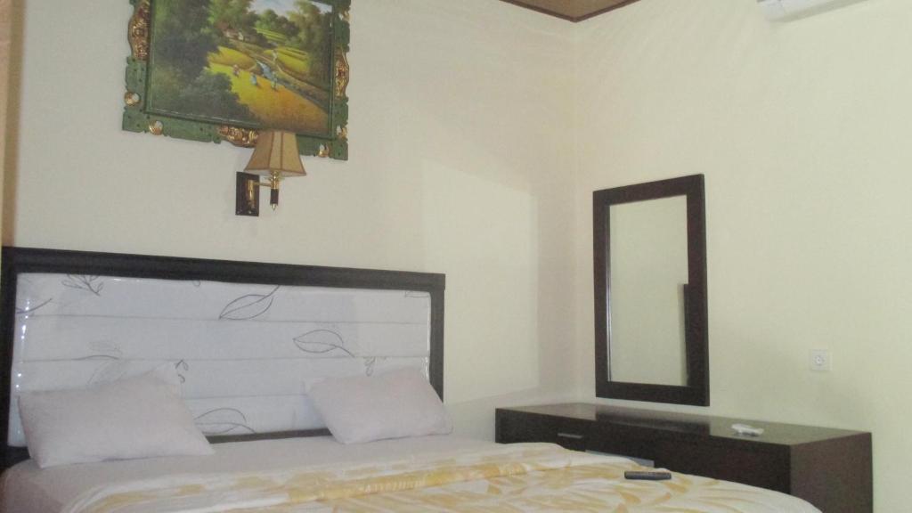 Postel nebo postele na pokoji v ubytování Adus Beach Inn