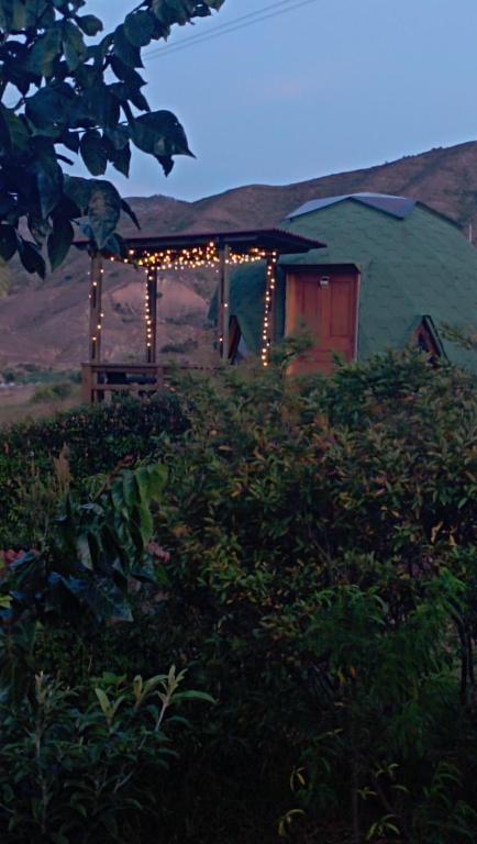 a tent in the middle of a field with lights at Los Nopales Glamping in Sáchica