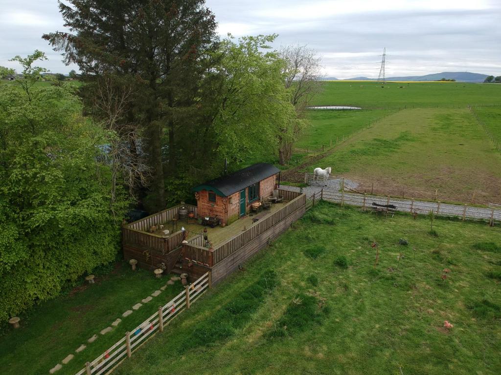 an aerial view of a house in a field at Cushieston’s Shepherd’s Hut in Meikle Wartle