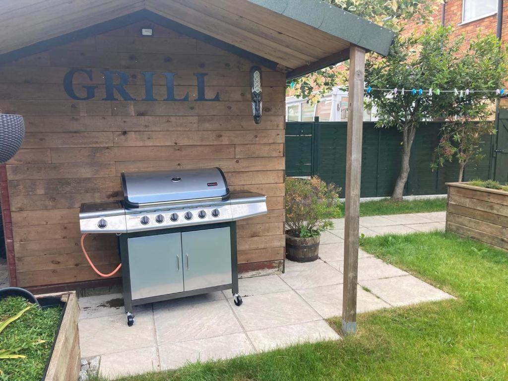 a barbecue grill in a backyard with a fence at Peasholm Luxury House in Scarborough