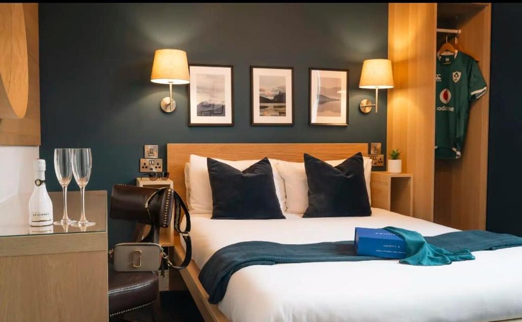 a bedroom with a large bed with a blue blanket at Celtic Lodge Guesthouse - Restaurant & Bar in Dublin