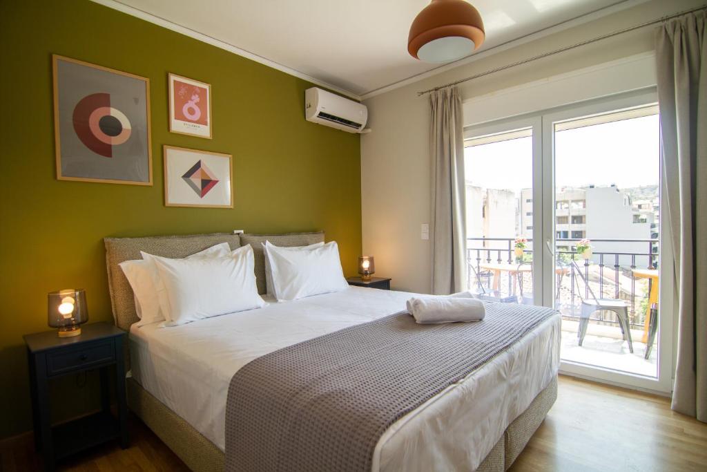 a bedroom with a large bed and a balcony at Acropolis View - 500m Metro - At Historical Center in Athens