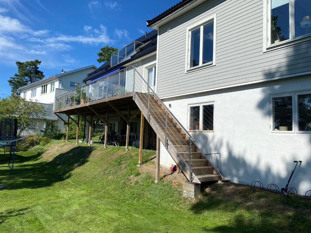 a house with a staircase leading up to a house at Stort hus i Stockholm in Sollentuna