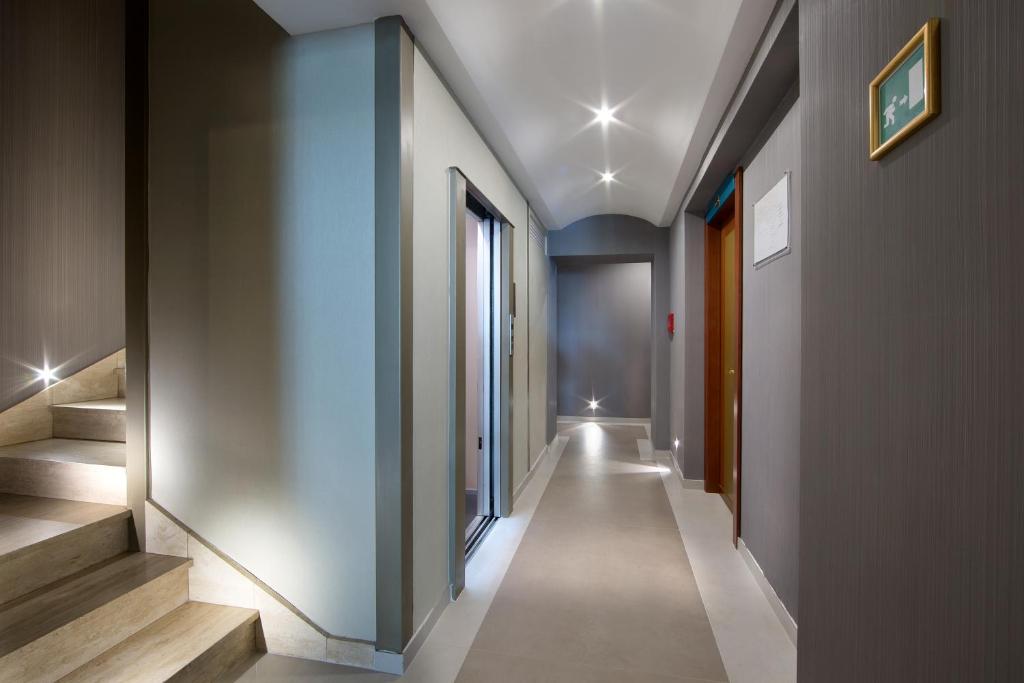 a hallway of a building with stairs and windows at Montespina Park Hotel in Naples