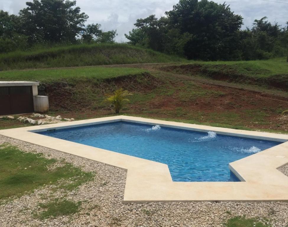 a swimming pool in the middle of a yard at Beach House in Playa Junquillal