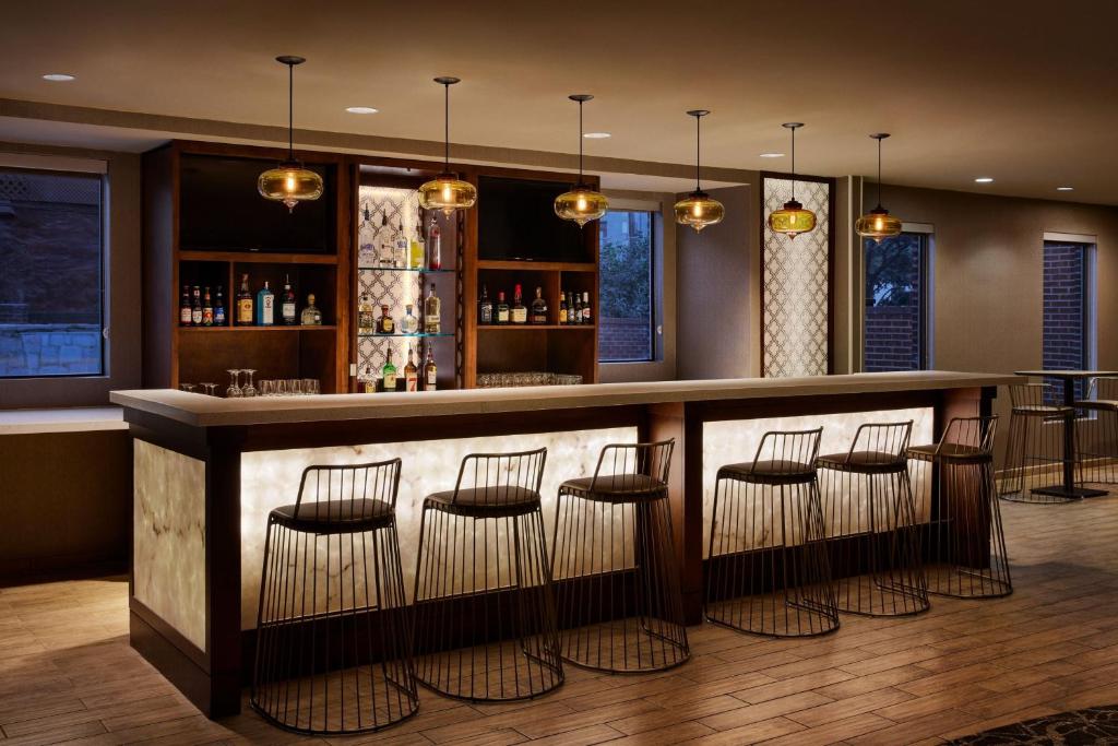 a bar in a restaurant with stools at SpringHill Suites by Marriott San Antonio Downtown-Riverwalk Area in San Antonio