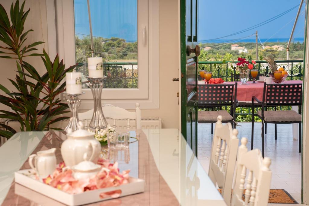 a dining room with a table and a view of the ocean at Ariadni Sea View Apartment in Minia