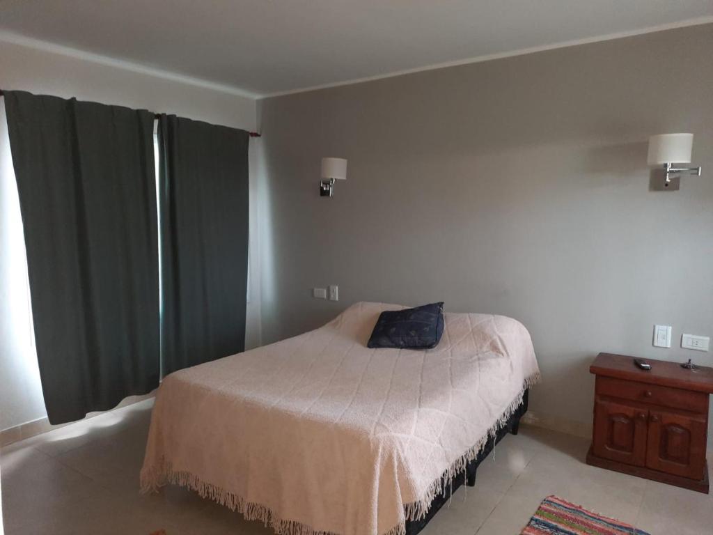 a bedroom with a bed with a pillow on it at Casa de Campo en Salta in Salta