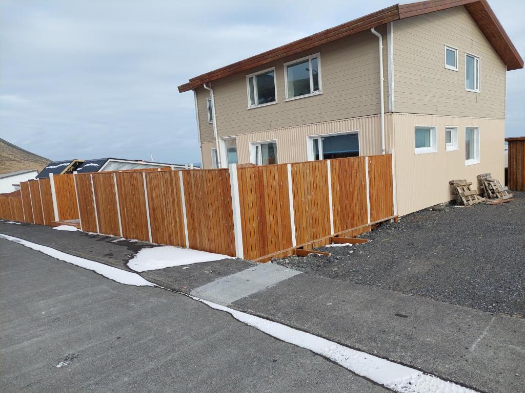 une clôture en bois devant une maison dans l'établissement Olafsvik Guesthouse, à Ólafsvík