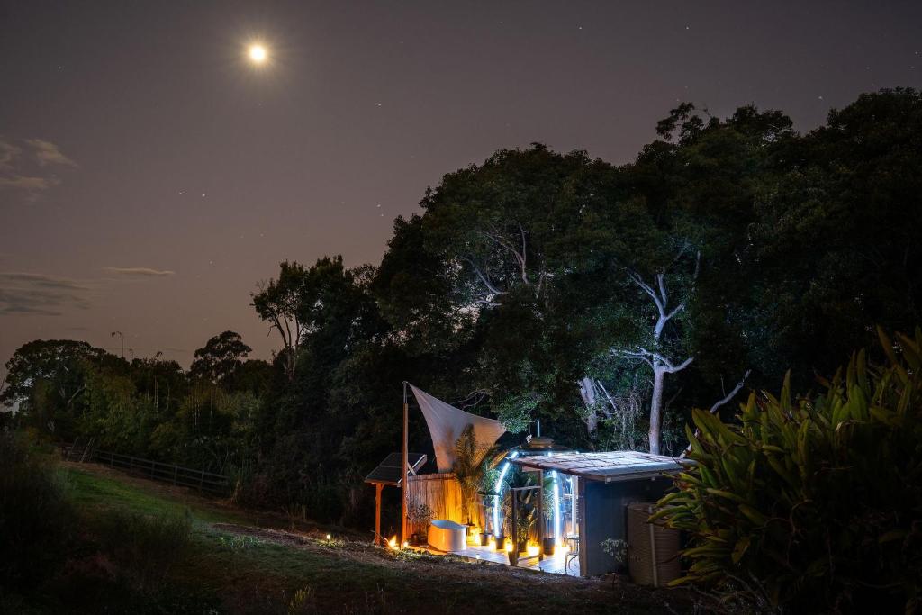 a small house at night with the moon in the sky at Kokoon Retreats - Northern Rivers NSW in Bilambil Heights