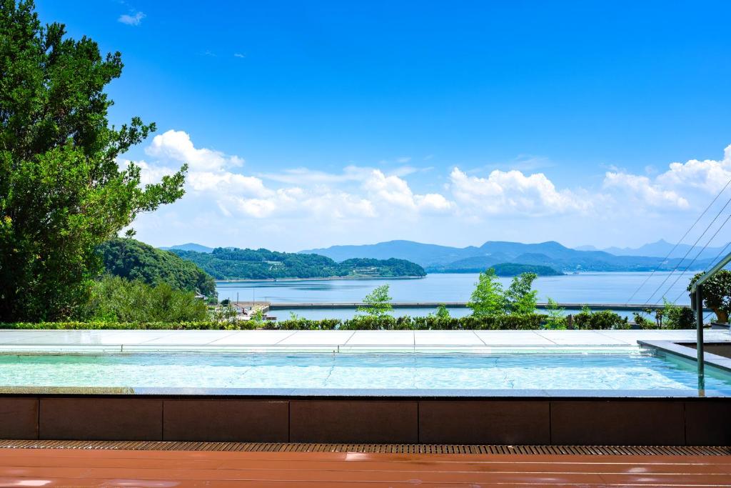 a swimming pool with a view of a lake at TAOYA Saikaibashi in Sasebo