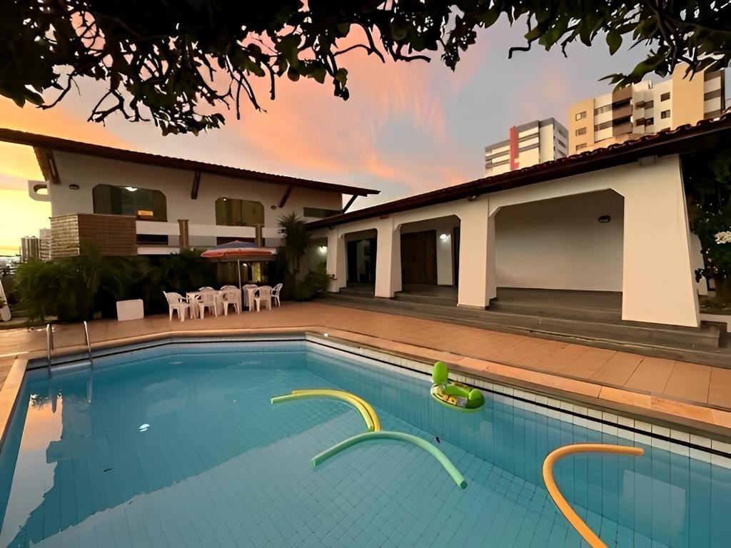 a swimming pool in front of a house at Casa Mais in Aracaju