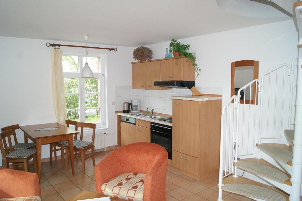 a kitchen and dining room with a table and chairs at Maisionette Wohnung im Hafenmeisterhaus Lauterbach in Lauterbach