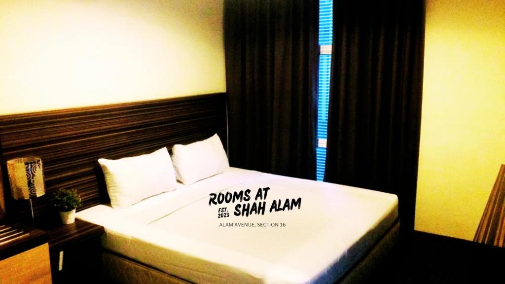a hotel room with a bed with a sign on it at Rooms at Hotel Shah Alam in Shah Alam