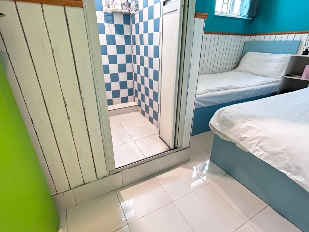 Postel nebo postele na pokoji v ubytování 香港名都商务旅馆 Ming Du Guesthouse