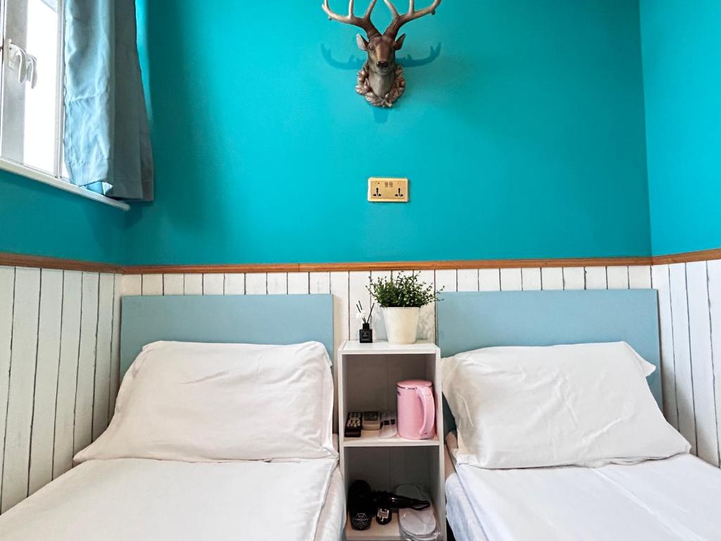 Postel nebo postele na pokoji v ubytování 香港名都商务旅馆 Ming Du Guesthouse