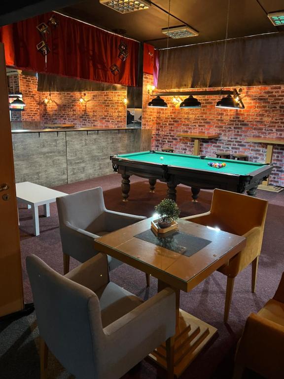 a room with a pool table and two chairs at Villa Abi Center in Struga